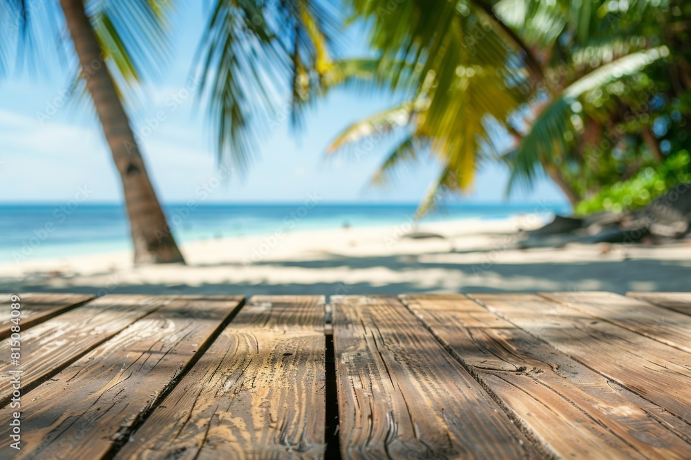 Poster empty wooden table top with a blurred beach and palm trees in the background for product display pre