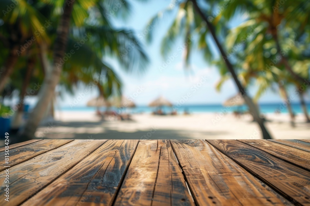 Poster empty wooden table top with a blurred background of a tropical beach and palm trees for product disp