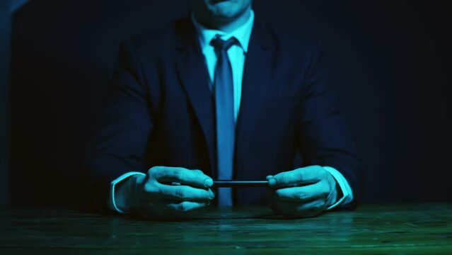 A man in a business suit gestures with light pencil explain client case. The pencil draws an imaginary exponent curve.