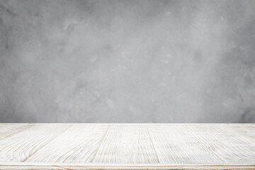 White wooden table with gray concrete wall background