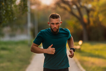 Fototapeta premium Sporty man running or jogging at the park active healthy lifestyle.