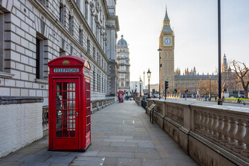 Red telephone box on Parliament square and Big Ben tower, London, UK