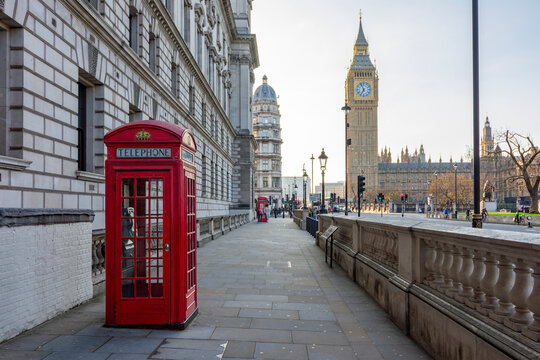 Red telephone box on Parliament square and Big Ben tower, London, UK