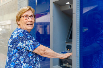 Old woman using the ATM