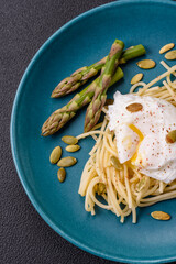 Delicious hearty breakfast consisting of poached eggs on toast with cream cheese, asparagus