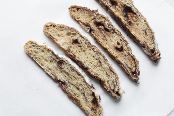 Overhead view of sliced date jam filled bread, flatlay of date filled bread slices on white background