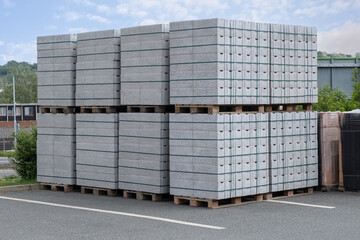 Concrete Cinder Blocks in Industrial Pallets, Grey brick Shapes building material. New for use on construction site or store in europe