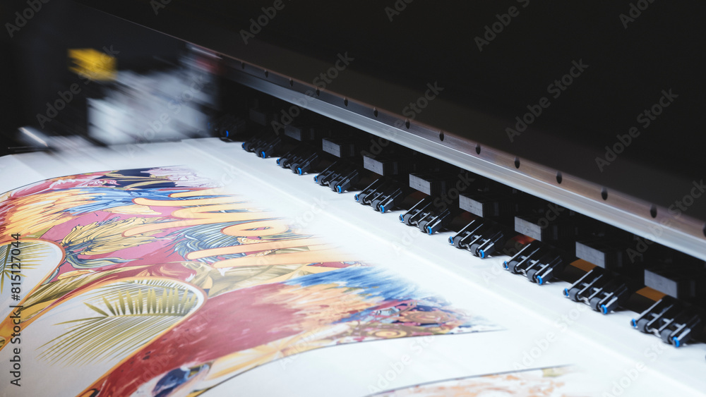 Poster A printer is printing a colorful design on a piece of paper. The design features a variety of shapes and colors, including a large flower and a bird. Scene is vibrant and lively, with the colors