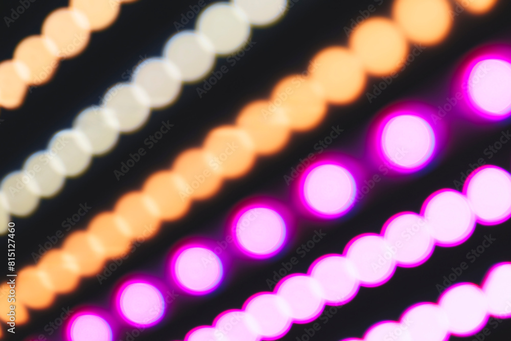 Poster A series of colorful lights are displayed in a row. The lights are in different colors and are arranged in a way that creates a sense of movement and energy. Scene is vibrant and dynamic