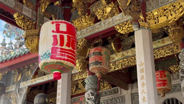 traditional Chinese lanters and gold leaf beams at Leong San Tong Khoo Kongsi temple clanhouse in George Town, Penang, Malaysia