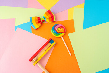 Colorful background with Lolly pop, wooden noisemaker, clown bow tie for Jewish holiday Purim.