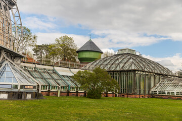 Naklejka premium Berlin, Germany - 20 April 2024, Berlin botanical Gardens Greenhouse, historical building beautiful sky