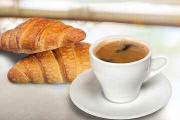 Autumn aesthetic with cup of coffee with fresh croissants