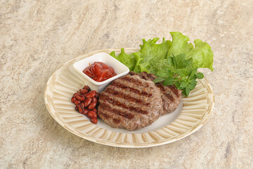 Grilled beef burger cutlet with sauce