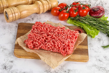 Raw minced beef meat on cutting board