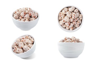 Roasted peanuts in sugar syrup and sesame seeds in a bowl on a white isolated background