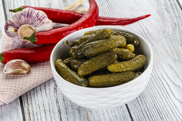 Marinated small cucumbers in the bowl
