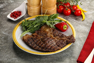 Grilled chuck roll steak with arugula