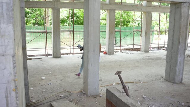 
A building inspector and a construction manager discuss and check the progress of a construction site, ensuring everything meets regulations and plans.