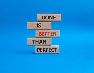 Done is better than Perfect symbol. Wooden blocks with words Done is better than Perfect. Beautiful blue background. Business concept. Copy space.