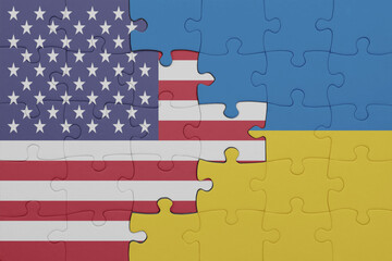 puzzle with the colourful national flag of ukraine and flag of united states of america .