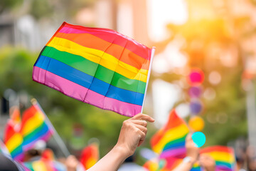 Hands are waving rainbow flags at the annual Pride Parade