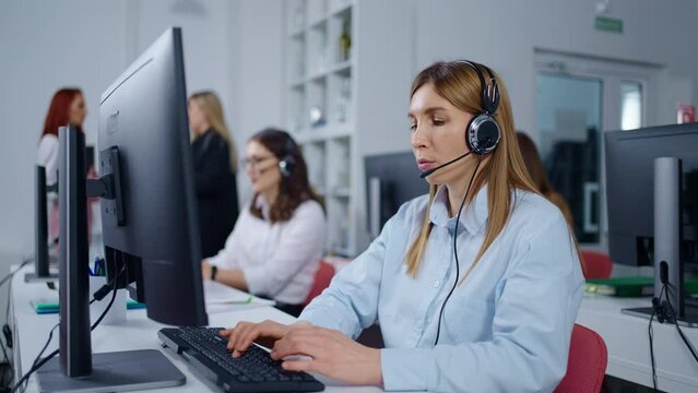 Portrait Of Woman Employee In Contact Center Of Bank Or Insurance Company, Workers With Headset