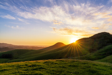Sunset, sun star, over hillside, mountainside