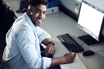Man, student and portrait with writing in book at IT college with smile for education with coding. Person, e learning and mockup space on computer screen for programming, study and academy in Mumbai