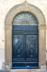 Ornate green door in the old center in Volterra, Tuscany, Italy, Europe