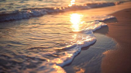 Closeup of the beach with gentle waves, the sun setting in the background, creating an atmosphere of tranquility and serenity.