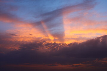a sunset sky with clouds and a purple sky with a few clouds.