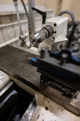 Detail of a countersink drill clamped in a lathe head.