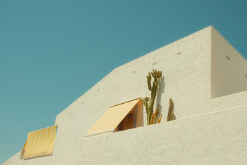 Architectural detail of white Mediterranean house by the sea in sunny day in Spain