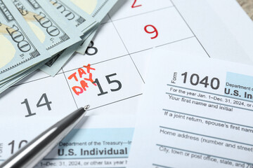 Tax day. Calendar with date reminder, documents, dollar banknotes and pen on table