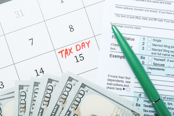 Tax day. Document, dollar banknotes and pen on calendar with date reminder, flat lay