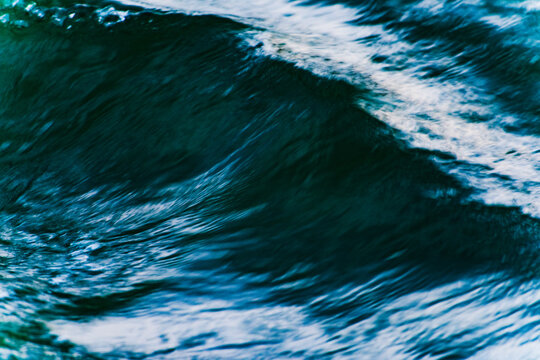 macro blue wave pattern in a river with motion blur