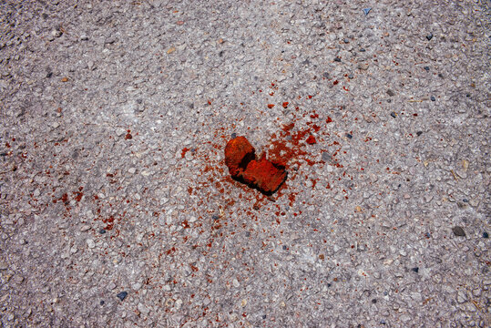 A rusted piece of metal of unknown origin lies on the asphalt in Austin, Texas