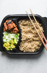 Overhead view of rice mackerel bowl in a takeaway plate, top view of healthy rice bowl meal prep,...