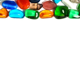 Colorful gem stones on white background with copy space for message. Background for design purpose.