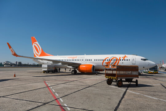 S&atilde;o Paulo, Brazil. Boeing 737-800 plane of Gol Airlines (Gol Linhas A&eacute;reas) company stopped at the Congonhas airport terminal on a sunny day.
