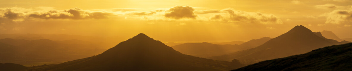 Panorama of yellow sunset with mountains from a view