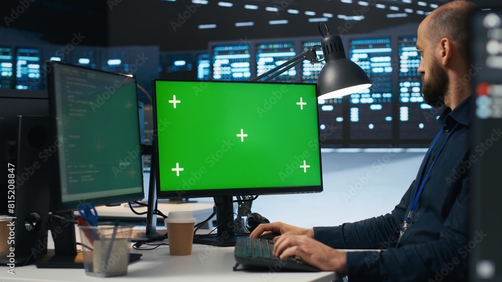 Poster it employee programming on green screen pc in data center housing supercomputers storing datasets. a