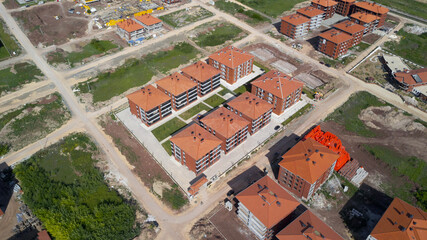 aerial view of the completed apartment complex and construction site
