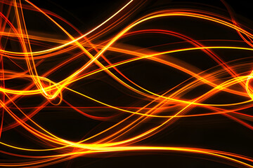 Luminous neon lines intersecting in shades of orange and yellow. Abstract art on black background.