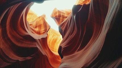 Abstract view of vibrant, wavy rock formations with hues of purple and red, illuminated by the setting sun.