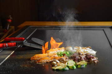 chef's hands with spatula over teppanyaki. Teppan show