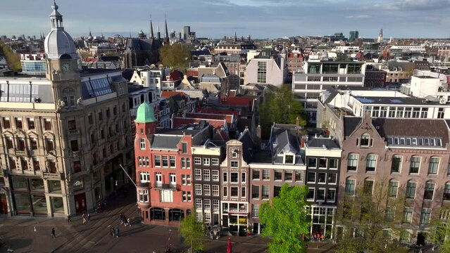 Historical Center of Amsterdam, Netherlands. Aerial Drone Shot of Traditional Dutch houses on narrow street and channel.