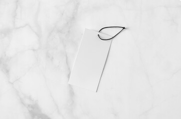 Rectangular clothing tag, gift tag mockup on a white marble background.