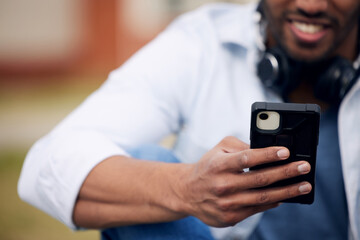 Man, student and hands typing with phone for social media, communication or reading news at college. Closeup of male person with smile on mobile smartphone for online chatting, outdoor texting or app